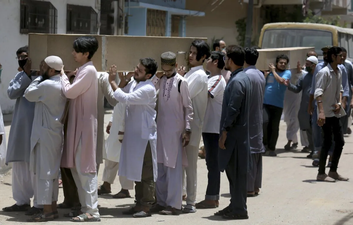 People carry the casket of the victims of Friday's plane crash for funeral prayers in Karachi, Pakistan, on May 23, 2020. (Fareed Khan/AP Photo)