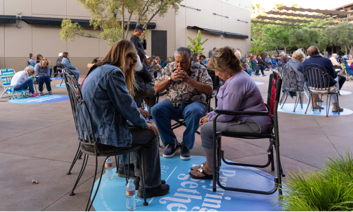A family prays together in the courtyard of Calvary Chapel Chino Hills during the COVID-19 pandemic in Chino Hills, Calif., in an undated file photo. (Courtesy of Calvary Chapel Chino Hills)