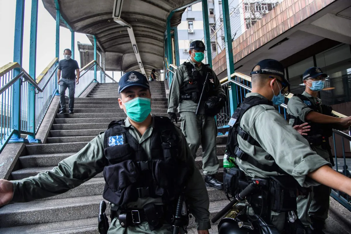 Riot police set up a cordon near a group of pro-democracy protesters (not pictured) during their route from outside the Western Police Station to the Chinese Liaison Office in Hong Kong on May 22, 2020. (Anthony Wallace/AFP via Getty Images)