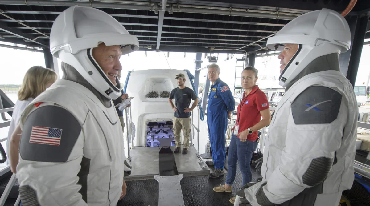 NASA astronauts Doug Hurley (L) and Bob Behnken work with teams from NASA and SpaceX to rehearse crew extraction from SpaceX's Crew Dragon, which will be used to carry humans to the International Space Station, at the Trident Basin in Cape Canaveral, Fla., on Aug. 13, 2019. (Bill Ingalls/NASA)