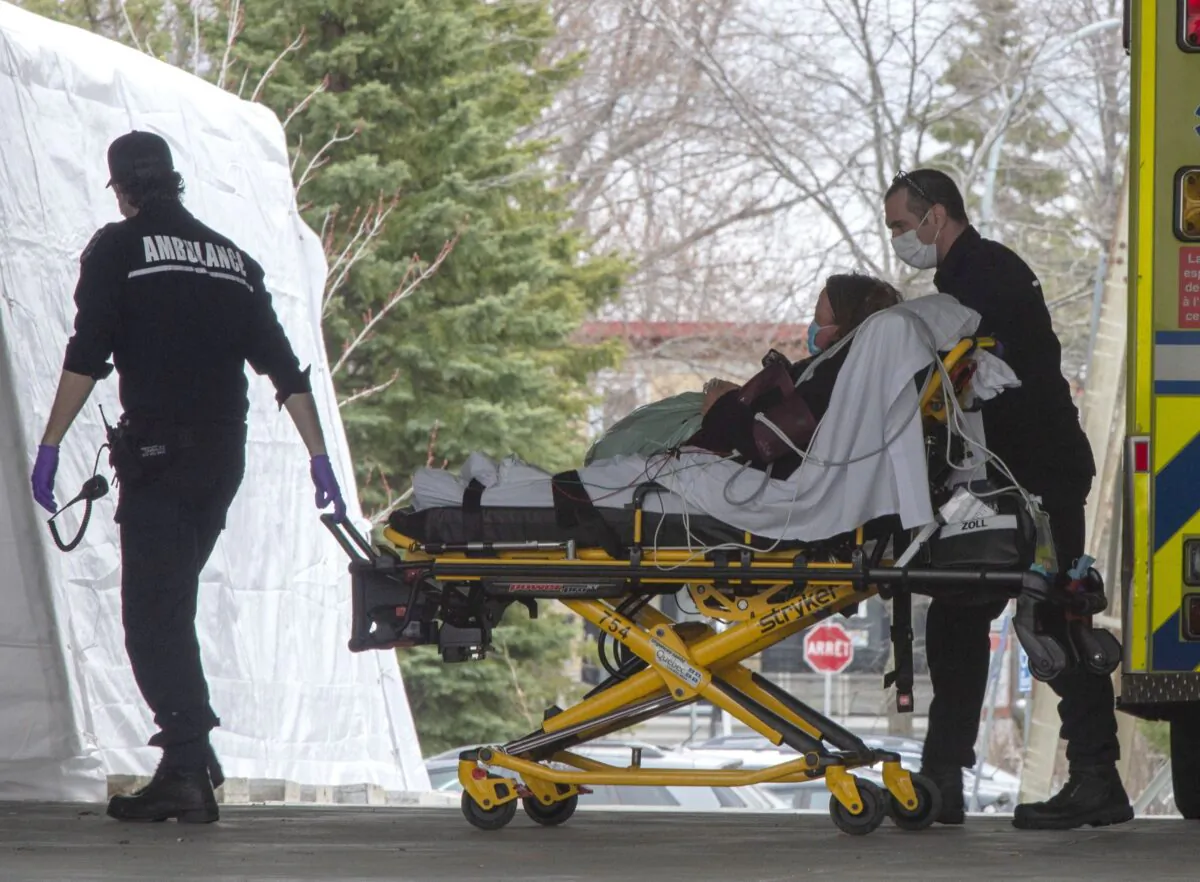 Ambulance workers take a patient to the emergency unit at Lasalle Hospital in Montreal on April 27, 2020. (The Canadian Press/Ryan Remiorz)
