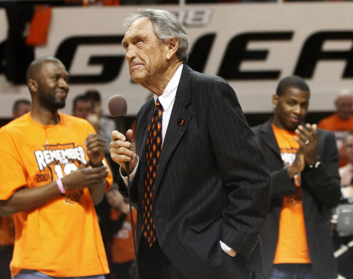 Former Oklahoma State coach Eddie Sutton, center, talks to fans during a ceremony honoring the 10th anniversary of the death of 10 members of the Oklahoma State basketball program in a plane crash, at halftime of an NCAA college basketball game between Oklahoma State and Texas in Stillwater, Okla., on Jan. 26, 2011. (Sue Ogrocki/AP, file photo)