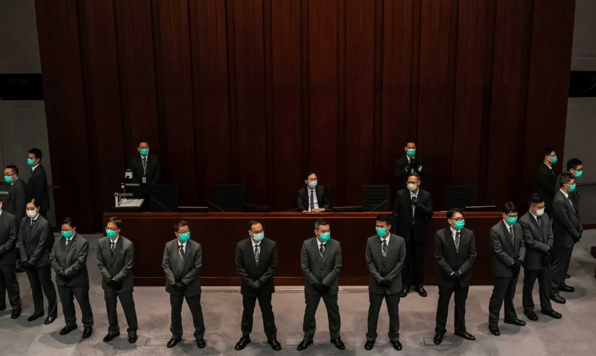 Pro-Beijing lawmaker Chan Kin Por is surrounded by security officers ahead of a meeting at the Legislative Council in Hong Kong on May 18, 2020. (Anthony Kwan/Getty Images)