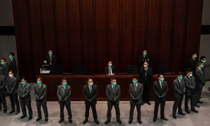 Pro-Beijing lawmaker Chan Kin Por is surrounded by security officers ahead of a meeting at the Legislative Council in Hong Kong on May 18, 2020. (Anthony Kwan/Getty Images)