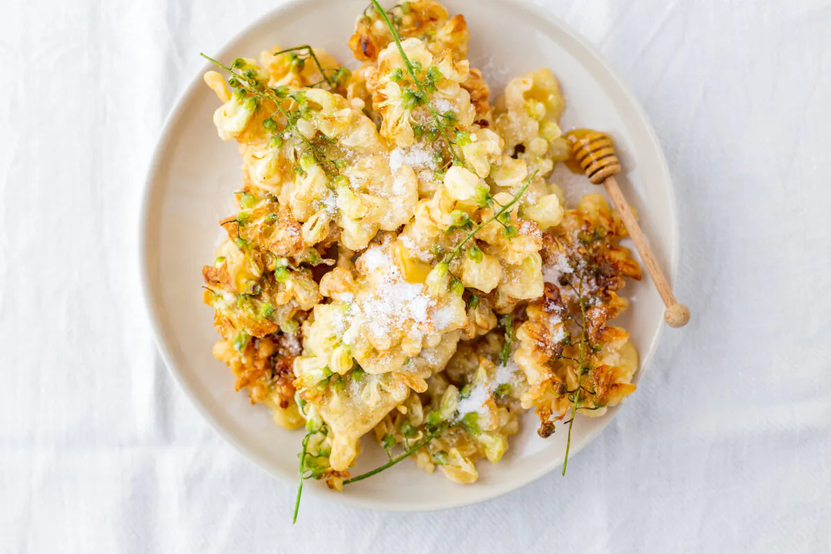 Black locust flower fritters have a heady, honeyed fragrance and delicate floral flavor. Sprinkle with sugar or drizzle with locust honey to serve. (Photo by Giulia Scarpaleggia)