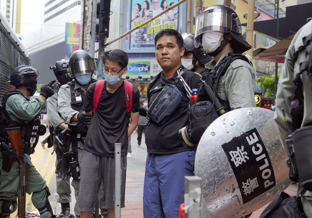 Riot police detain protesters in Causeway Bay, Hong Kong, as hundreds took to the streets to march against Beijing's proposed tough national security legislation for the city, on May 24, 2020. (AP Photo/Vincent Yu)