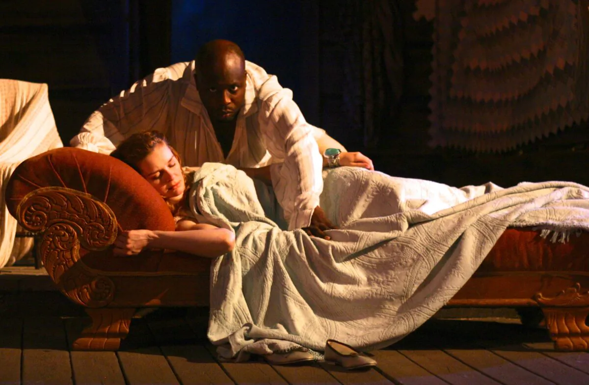 The cunning Iachimo (Jeff Award-nominee James Earl Jones II) steals into the bed chamber of innocent Imogen (Kate McDermott) to defame her character, First Folio Theatre’s 2013 production of “Cymbeline,” available for online viewing. (D. Rice)