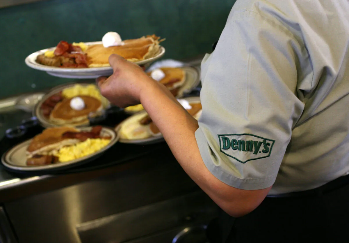 A Denny's employee in a file photograph. Fifteen franchisee locations are closing due to the COVID-19 pandemic in addition to a company-owned store. (Justin Sullivan/Getty Images)