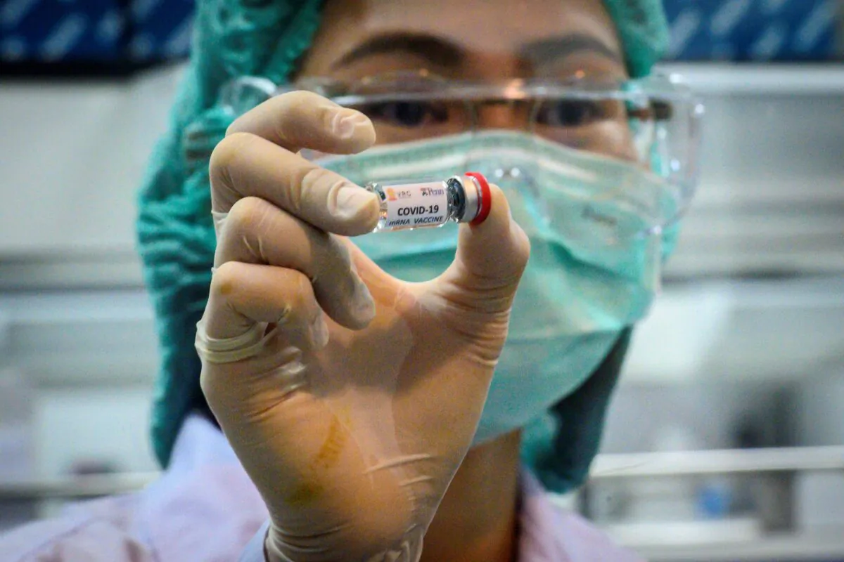 A laboratory technician holds a dose of a CCP virus vaccine candidate ready for trial on monkeys at the National Primate Research Center of Thailand at Chulalongkorn University in Saraburi on May 23, 2020. (Mladen Antonov/AFP via Getty Images)