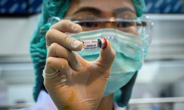 A laboratory technician holds a dose of a CCP virus vaccine candidate ready for trial on monkeys at the National Primate Research Center of Thailand at Chulalongkorn University in Saraburi on May 23, 2020. (Mladen Antonov/AFP via Getty Images)