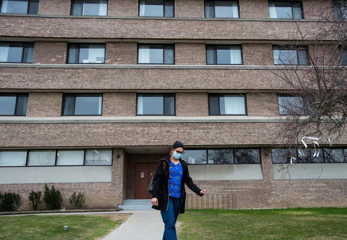 A healthcare worker leaves after finishing her shift for the day at the Eatonville Care Centre in Toronto on April 24, 2020. The facility as been one of the hardest hit care centres with the COVID-19 pandemic in the country. (Nathan Denette/THE CANADIAN PRESS)