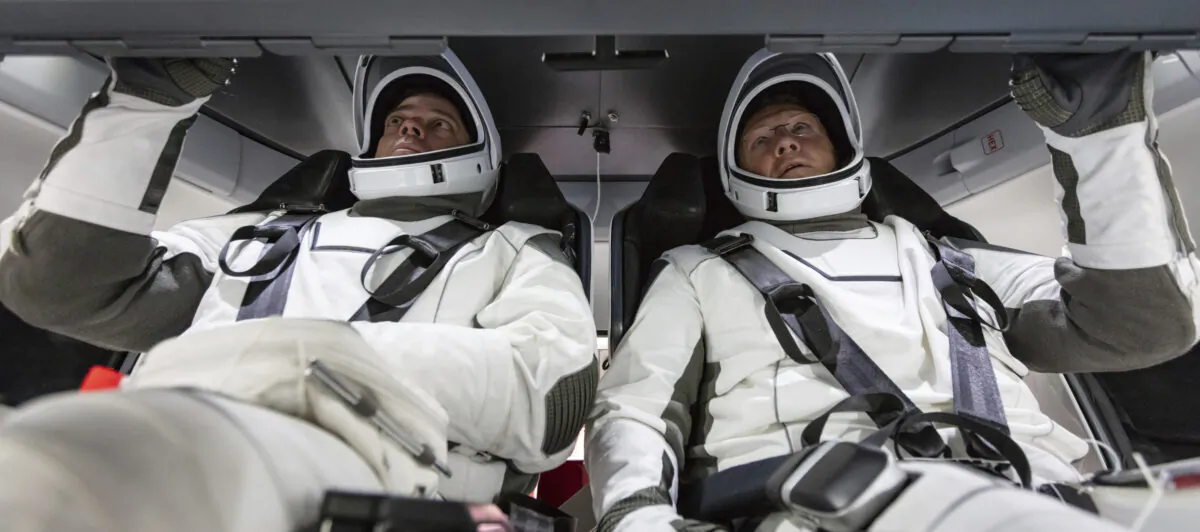 NASA astronauts Doug Hurley and Bob Behnken familiarize themselves with SpaceX's Crew Dragon, the spacecraft that will transport them to the International Space Station as part of NASA's Commercial Crew Program, at the Kennedy Space Center in Cape Canaveral, Fla., in August 2018. (SpaceX via AP)