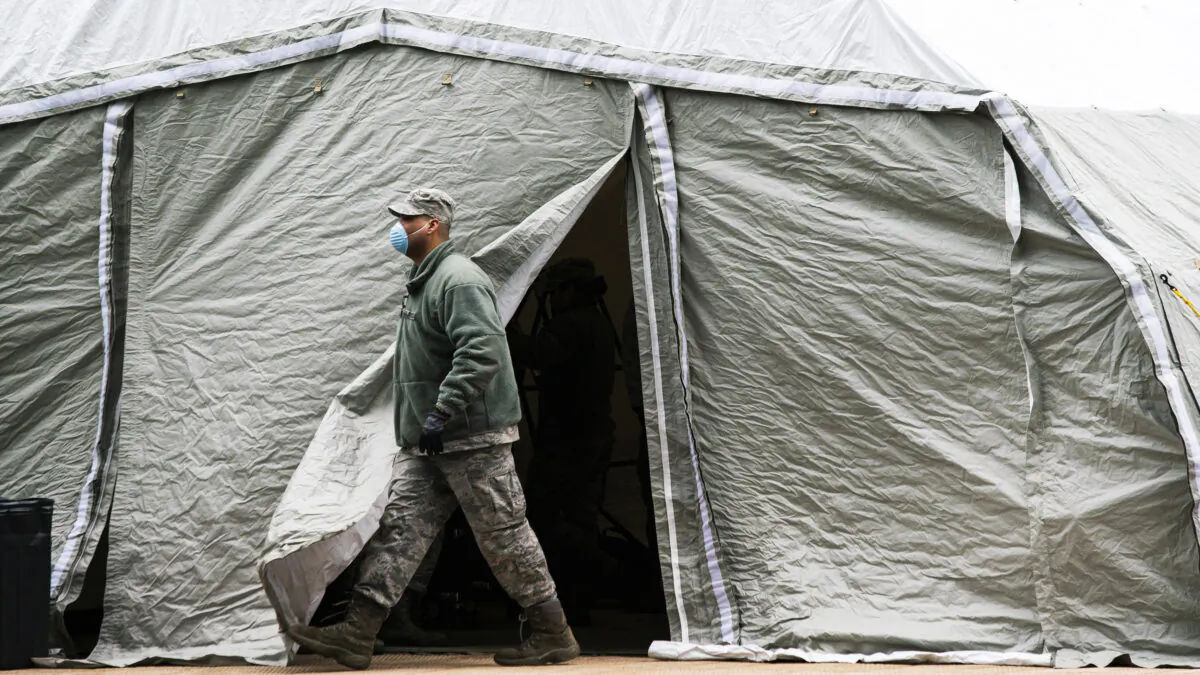An Air Force member exits a tent erected as a makeshift morgue outside of Bellevue Hospital in New York City on March 25, 2020. (Eduardo Munoz Alvarez/Getty Images)
