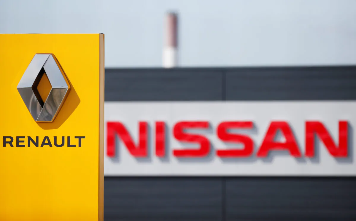 The logos of car manufacturers Renault and Nissan are seen in front of dealerships of the companies in Reims, France, on July 9, 2019. (Christian Hartmann/Reuters)