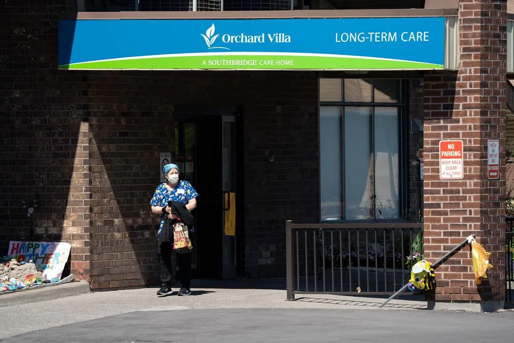 A home-care worker is shown outside Orchard Villa long-term care home in Pickering, Ont., on May 26, 2020. (Frank Gunn/The Canadian Press)