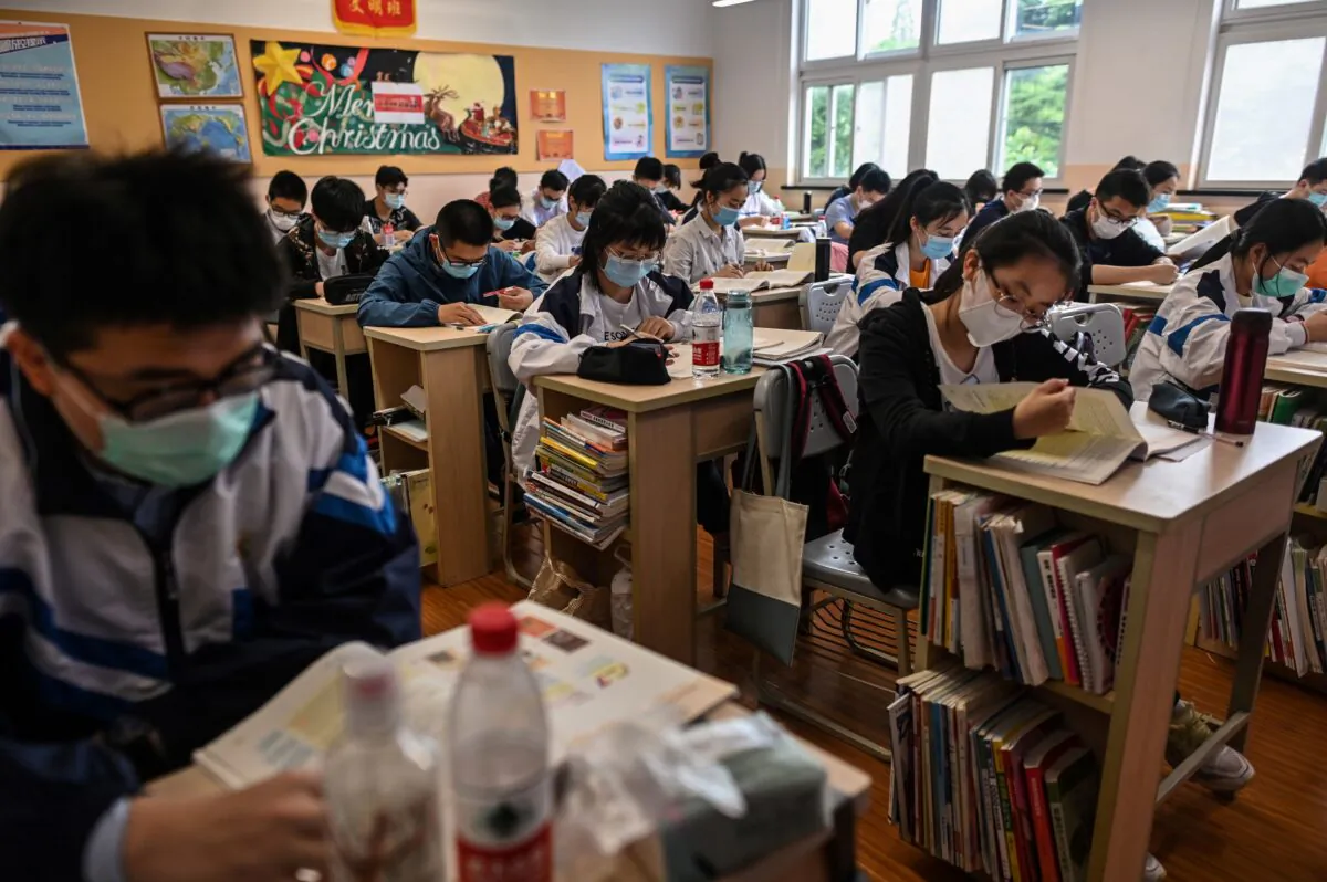 Students wearing face masks are seen in their classroom during a government organised media tour at Shanghai High School after it reopened in Shanghai, China on May 7, 2020. (HECTOR RETAMAL/AFP via Getty Images)