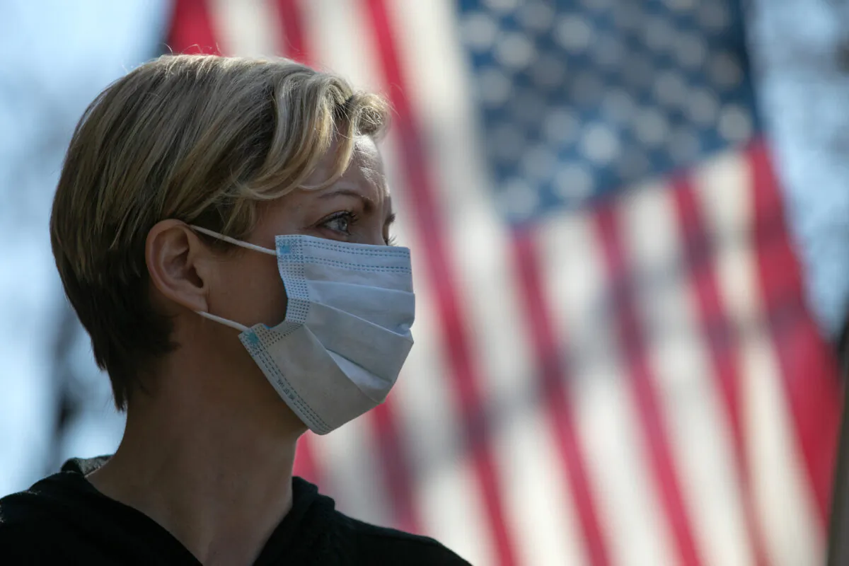 A virus crisis volunteer greets local residents arriving to a food distribution center at the WestCop community center in New Rochelle, New York on March 18, 2020. (John Moore/Getty Images)