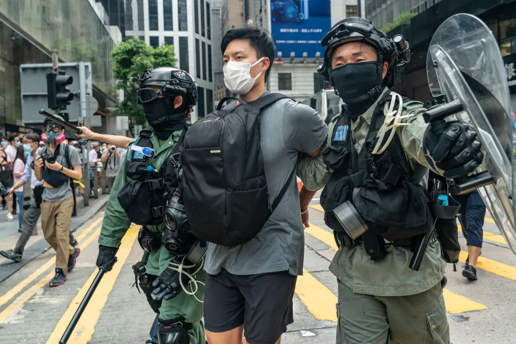  A pedestrian is detained by riot police during a Lunch with You rally in Central district in Hong Kong on May 27, 2020. (Anthony Kwan/Getty Images)