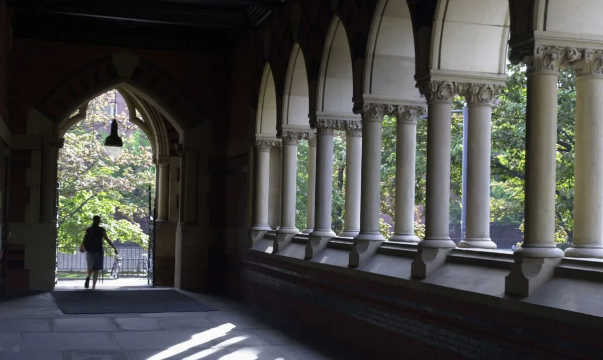 A student leaves Harvard's Memorial Hall in Cambridge, Mass., on Oct. 10, 2003. (William B. Plowman/Getty Images)