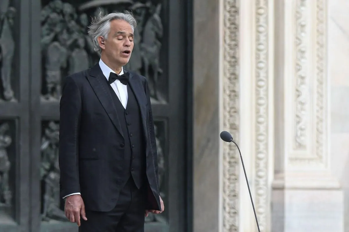 Italian tenor and opera singer Andrea Bocelli sings on a deserted Piazza del Duomo in central Milan, prior to an evening performance without public, on April 12, 2020. (Piero Cruciatti/AFP via Getty Images)