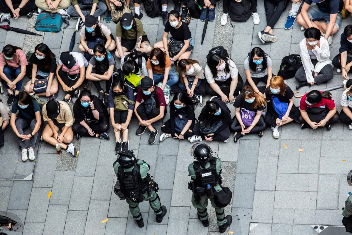 Riot police detain a group of people during a protest in the Causeway Bay district of Hong Kong on May 27, 2020. (Isaac Lawrence/AFP via Getty Images)