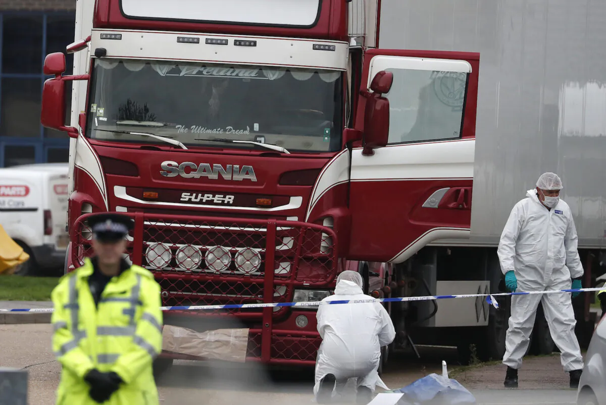 Forensic police officers attend the scene after a truck was found to contain a large number of dead bodies, in Grays, England, on Oct. 23, 2019. (Alastair Grant/AP/ file)