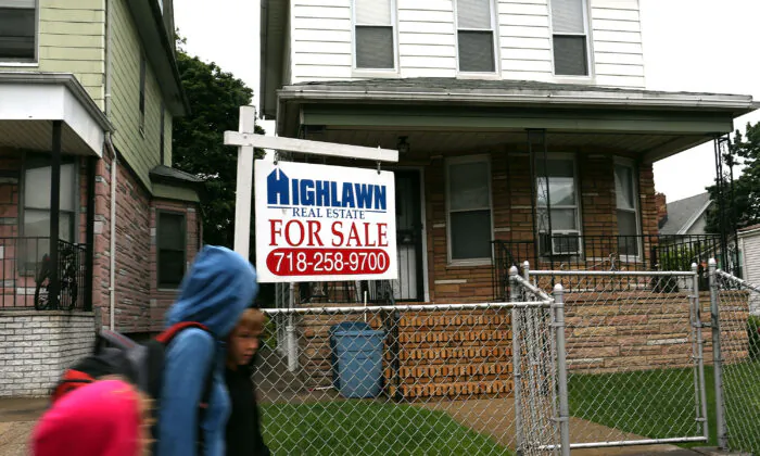  A "For Sale" sign hangs outside a home in the Brooklyn borough of New York City on June 12, 2012. (Spencer Platt/Getty Images)