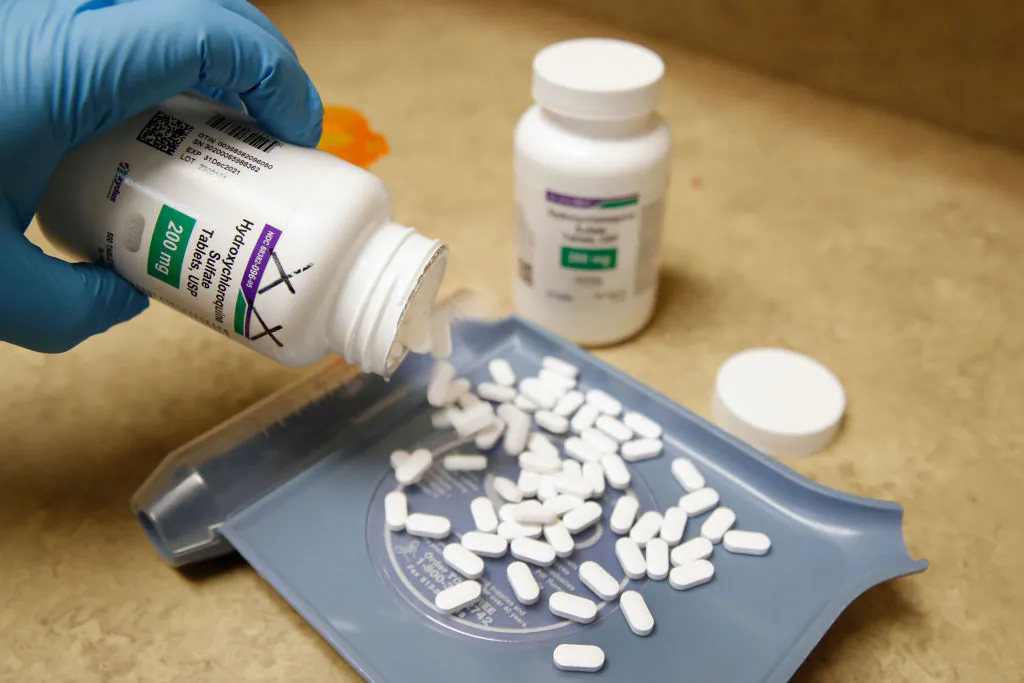A pharmacy tech pours out pills of hydroxychloroquine at Rock Canyon Pharmacy in Provo, Utah, on May 20, 2020. (George Frey/AFP via Getty Images)