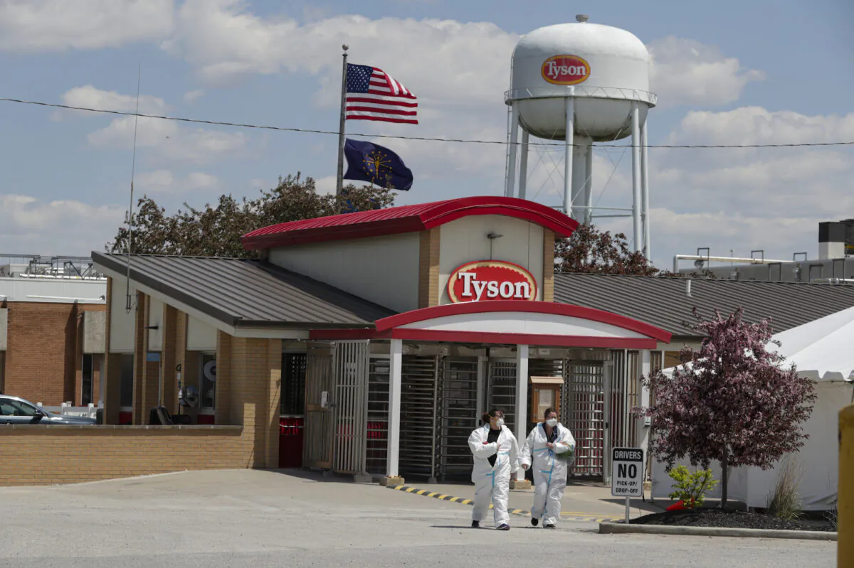 Workers leave the Tyson Foods pork-processing plant in Logansport, Ind., on May 7, 2020. (Michael Conroy/AP Photo)
