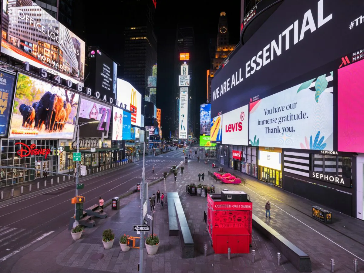 A handful of pedestrians walk through Times Square as streets remain relatively quiet due to the continuing outbreak of the CCP virus in the Manhattan borough of New York, on May 5, 2020. (Lucas Jackson/Reuters)