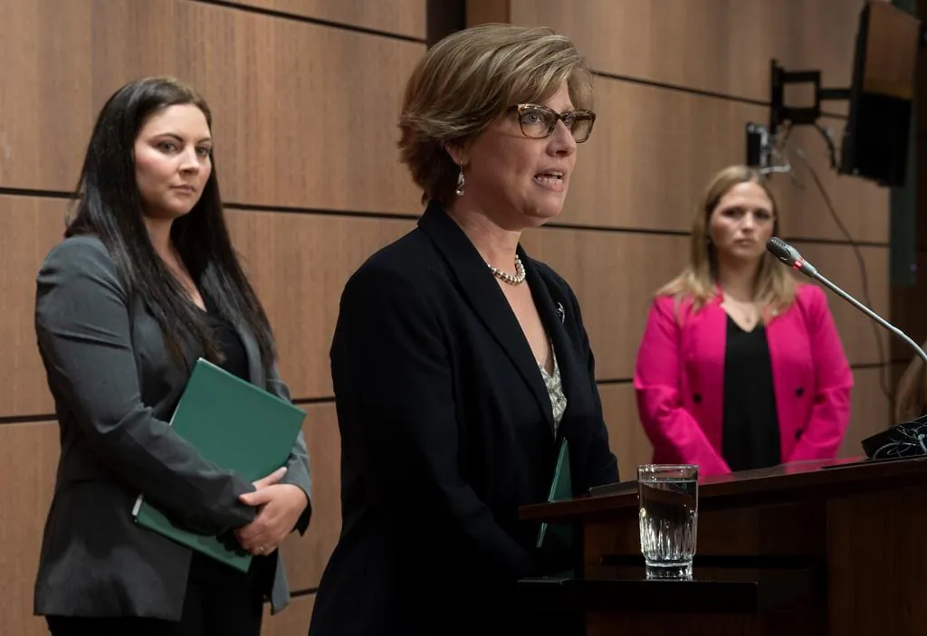 Green Party MP Jenica Atwin (left) and NDP Critic for Diversity and Inclusion and Youth, Women and Gender Equality Lindsay Mathyssen look on as Conservative Women and Gender Quality critic Karen Vecchio speaks during a news conference on May 28, 2020 in Ottawa. (Adrian Wyld/The Canadian Press)
