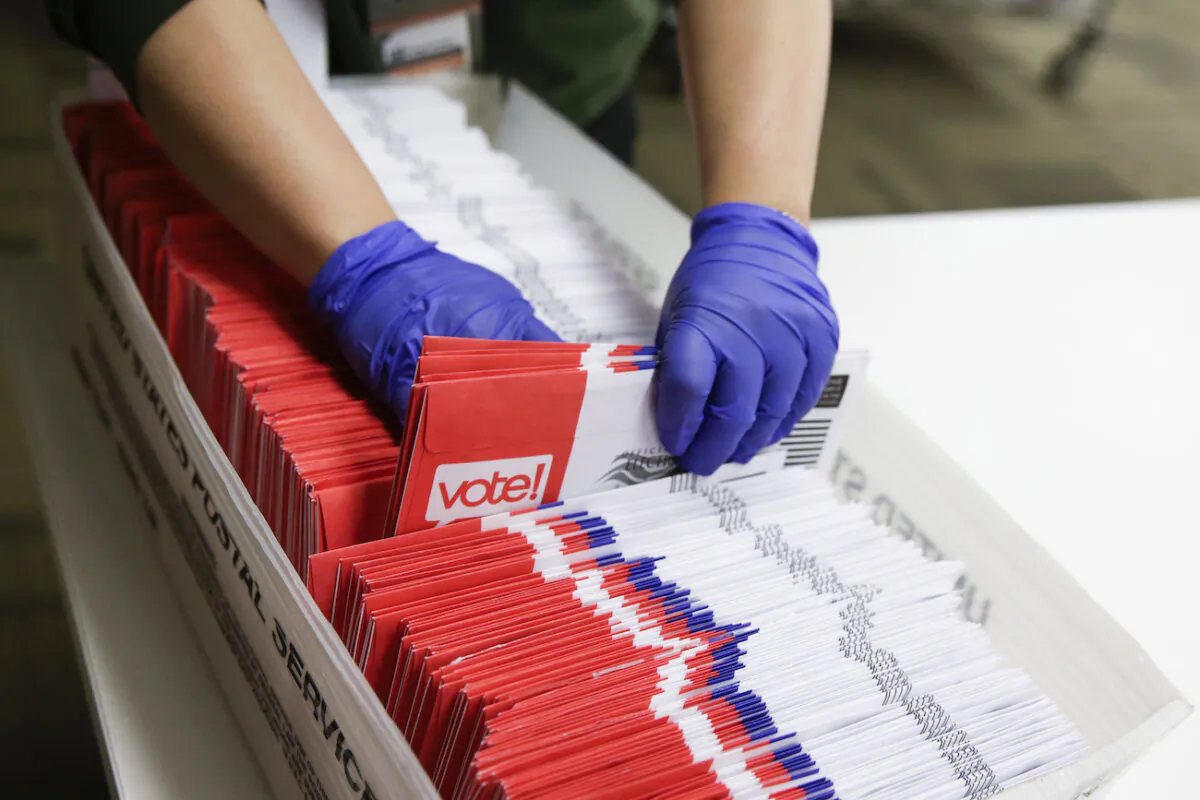 Election workers sort vote-by-mail ballots for the presidential primary at King County Elections in Renton, Wash., on March 10, 2020. (Jason Redmond/AFP via Getty Images)
