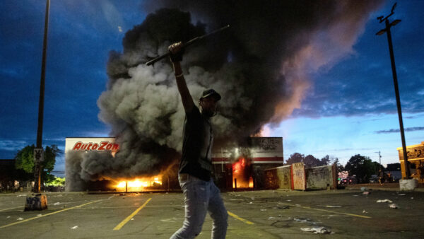 A man poses for a photo in the parking lot