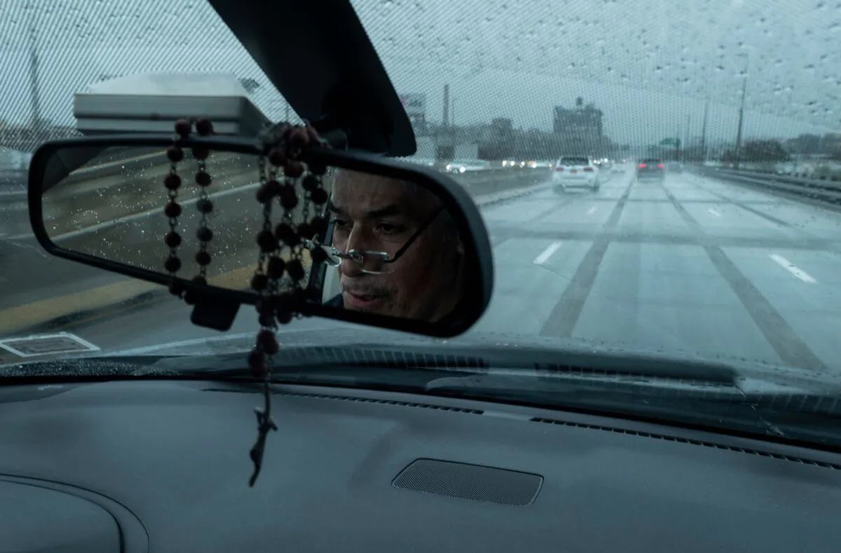 Fabian Arias, a Lutheran pastor with Saint Peter's Church is reflected as he drives his car in Brooklyn, New York City, on May 22, 2020. (Johannes Eisele/AFP via Getty Images)