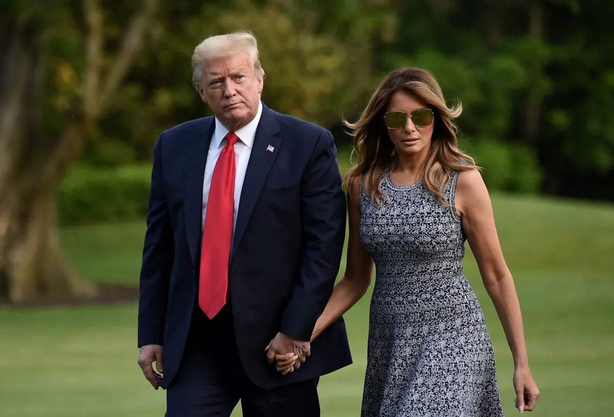 President Donald Trump and First Lady Melania Trump walk across the South Lawn upon return to the White House on May 27, 2020. (Olivier Douliery/AFP via Getty Images)