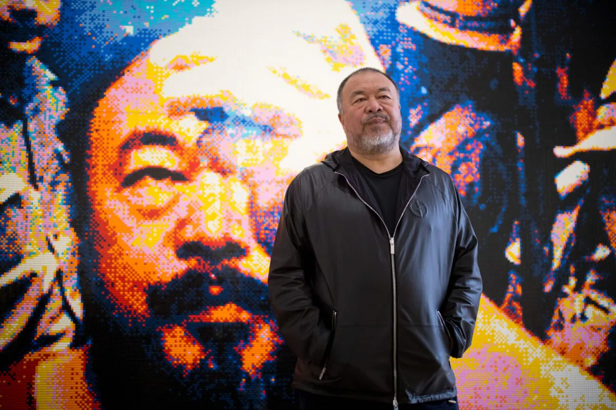 Chinese artist Ai Weiwei poses with his artwork made of Lego, entitled "Illumination 2019" during a photocall to promote his exhibition 'Roots' at the Lisson Gallery in London, England, on Oct. 1, 2019. (Tolga Akmen/AFP/Getty Images)