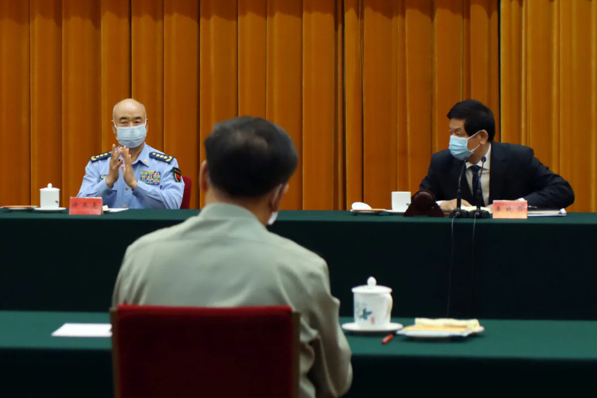 Li Zhanshu (R), chairman of National People's Congress (NPC) Standing Committee, Xu Qiliang, vice chairman of the Central Military Commission, and Li Zuocheng (C), chief of the Joint Staff Department, attend an event marking the 15th anniversary of the implementation of the Anti-Secession Law at the Great Hall of the People in Beijing, China, on May 29, 2020. (Yew Lun Tian/Reuters)