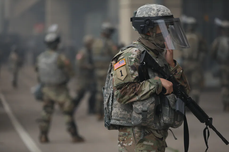 A National Guardsman stands near the Lake St. Midtown metro station after a night of protests and violence following the death of George Floyd, in Minneapolis, Minn., on May 29, 2020. (Charlotte Cuthbertson/The Epoch Times)