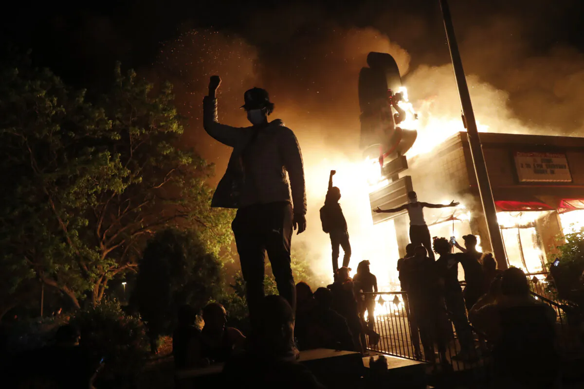 Rioters gather in front of a fast food restaurant in Minneapolis, Minn. on May 29, 2020. (John Minchillo/AP Photo)