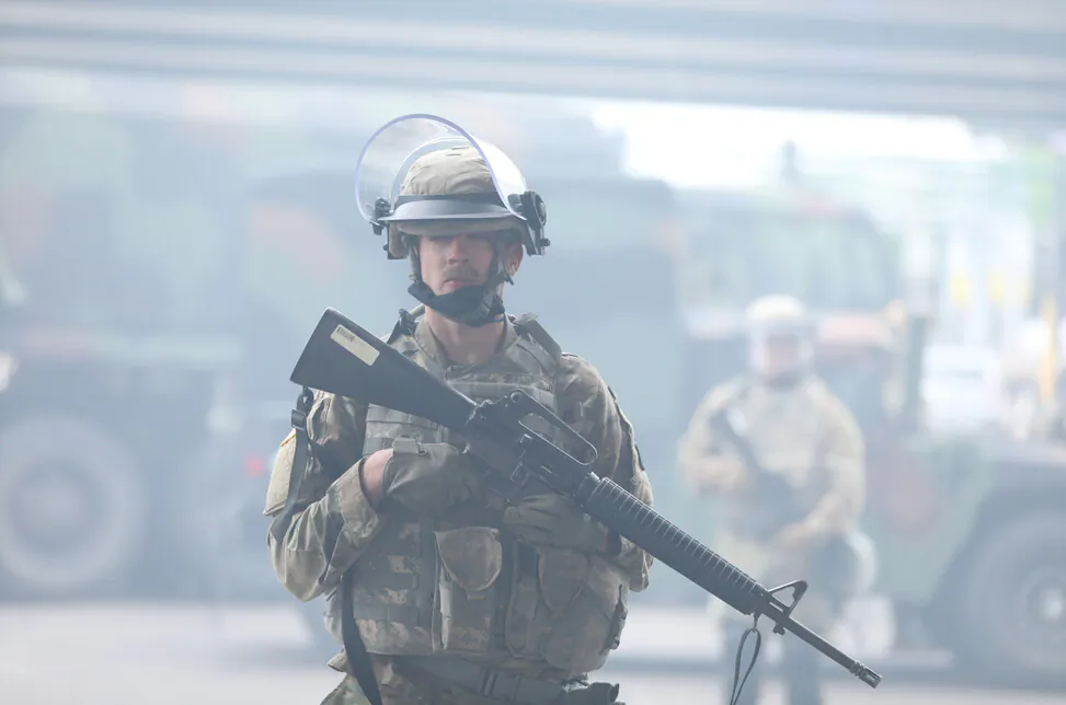 A National Guardsman stands near the Lake St. Midtown metro station after a night of protests and violence following the death of George Floyd, in Minneapolis, Minn., on May 29, 2020. (Charlotte Cuthbertson/The Epoch Times)