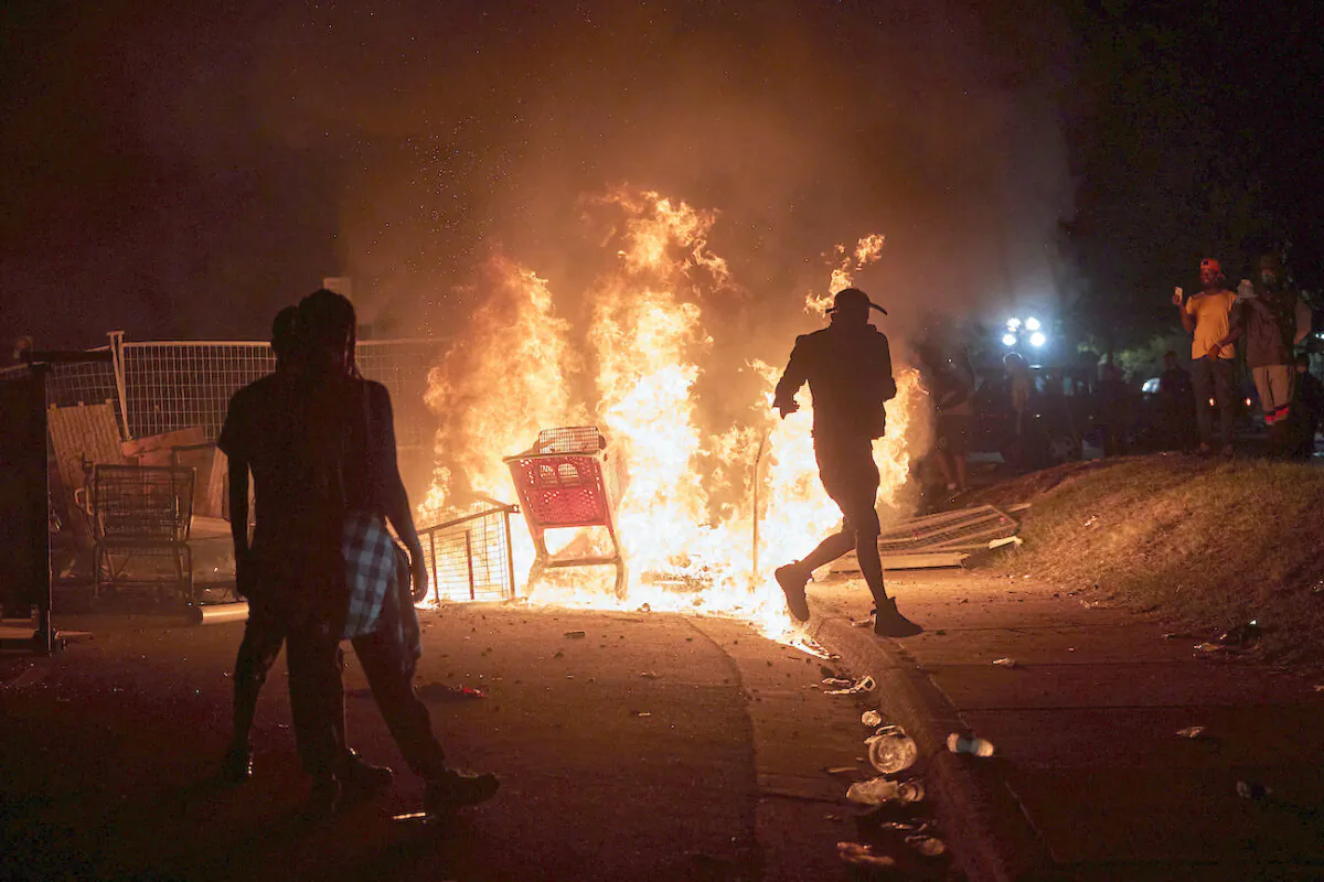 Protesters gather to watch shopping carts burning near the Minneapolis Police third precinct in Minneapolis, Minnesota, on May 27, 2020. (Adam Bettcher/Reuters)