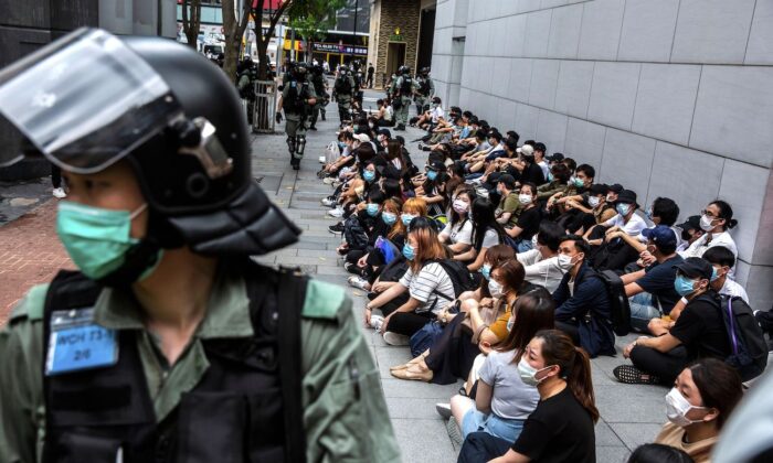 Riot police detain a group of people during a protest in the Causeway Bay district of Hong Kong as the city's legislature debates over a law that bans insulting China's national anthem on May 27, 2020. (Isaac Lawrence/AFP via Getty Images)