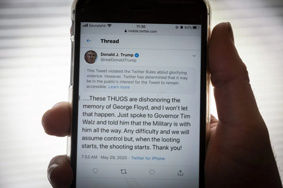 The censored tweet from U.S. President Donald Trump, on a phone in Finland, on May 29, 2020. (Olivier Morin/AFP via Getty Images)