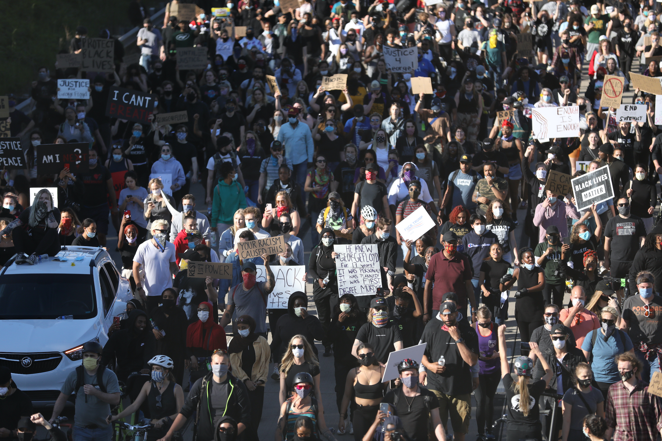 Protesters march along the freeway