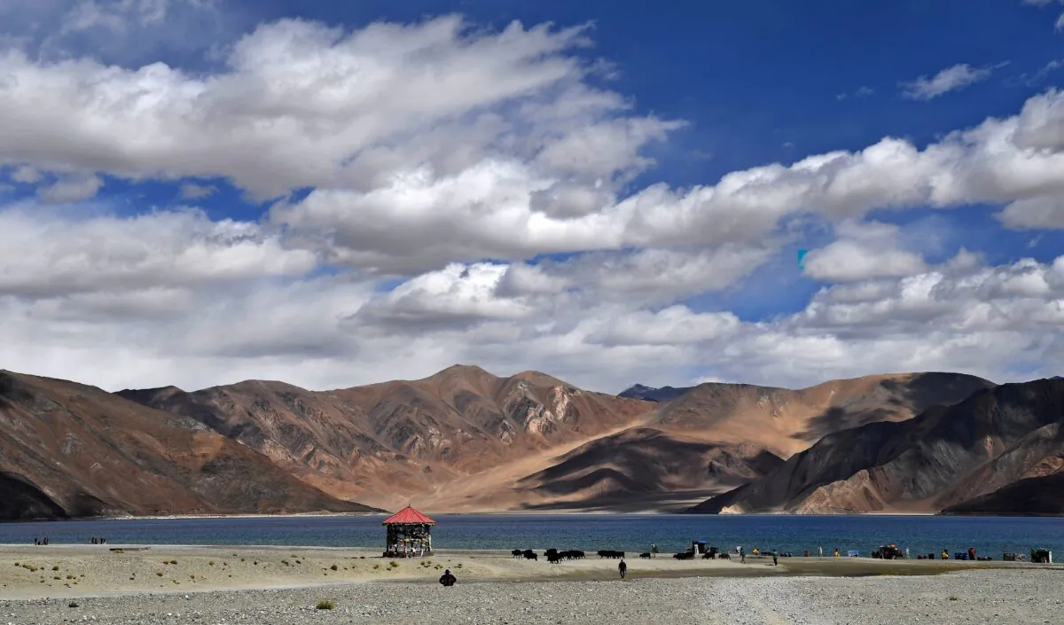 Tourists taking selfies as cows gaze in front of the Pangong Lake in Leh district of Union terrritory of Ladakh bordering India and China on Sept. 14, 2018. Indian defence sources said hundreds of Chinese troops had moved into a disputed zone along their 3,500 kilometre-long (2,200 mile) frontier after recent skimishes. (Prakash Singh/AFP/Getty Images)