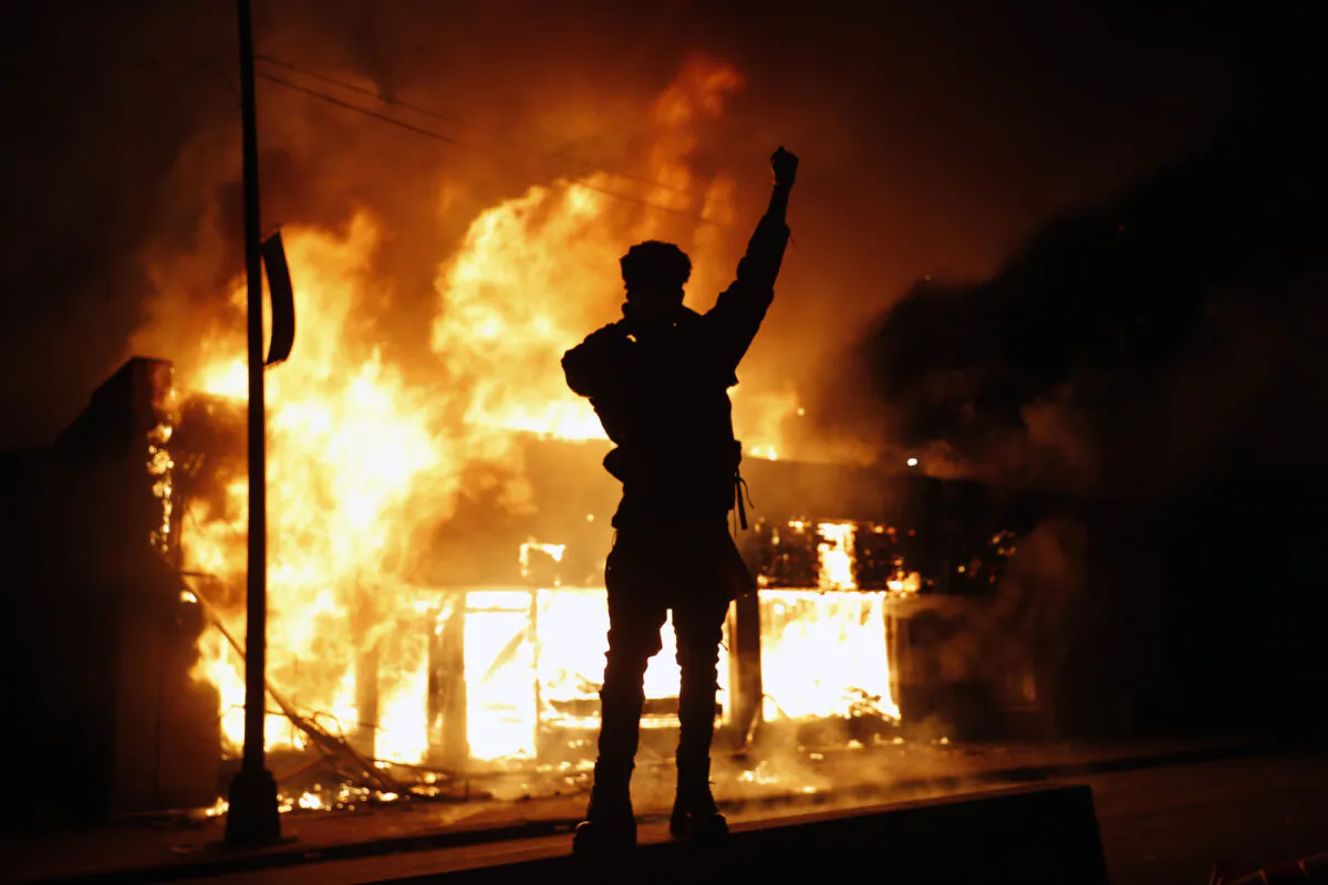 A check-cashing business burns in Minneapolis, Minn., on May 29, 2020. (John Minchillo/AP Photo)