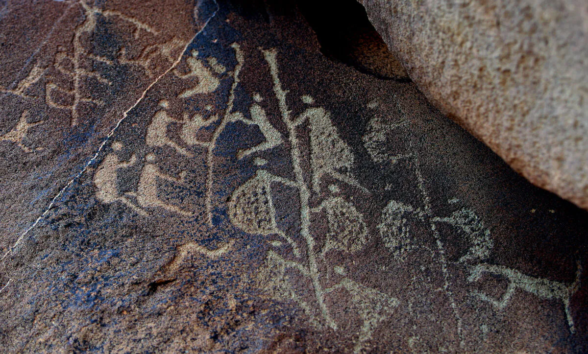 The ancient Aboriginal rock carving known as 'Climbing Man' (C), believed to be thousands of years old Burrup Peninsula, Western Australia, June 17, 2008. (GREG Wood/AFP via Getty Images)