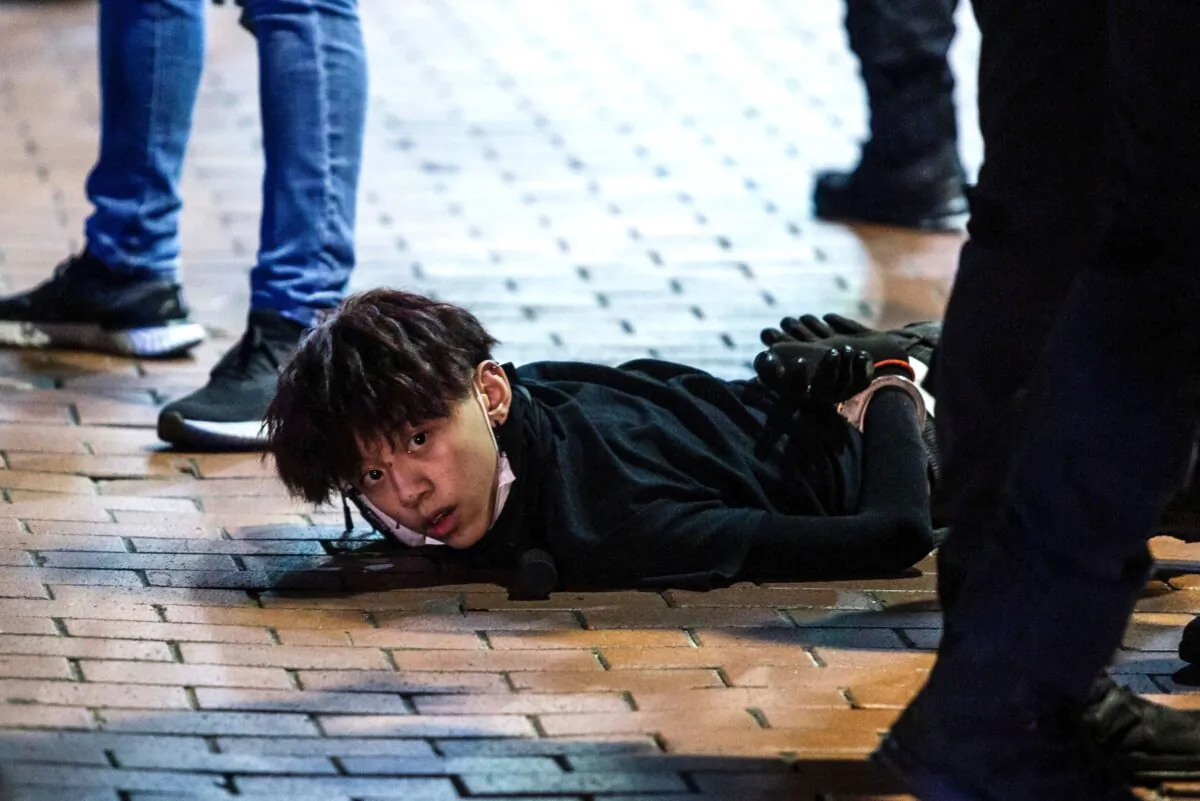 Undercover police arrest and handcuff a pro-democracy demonstrator (C) during a pro-democracy protest in Mong Kok district of Hong Kong on May 10, 2020. (Isaac Lawrence/AFP via Getty Images)