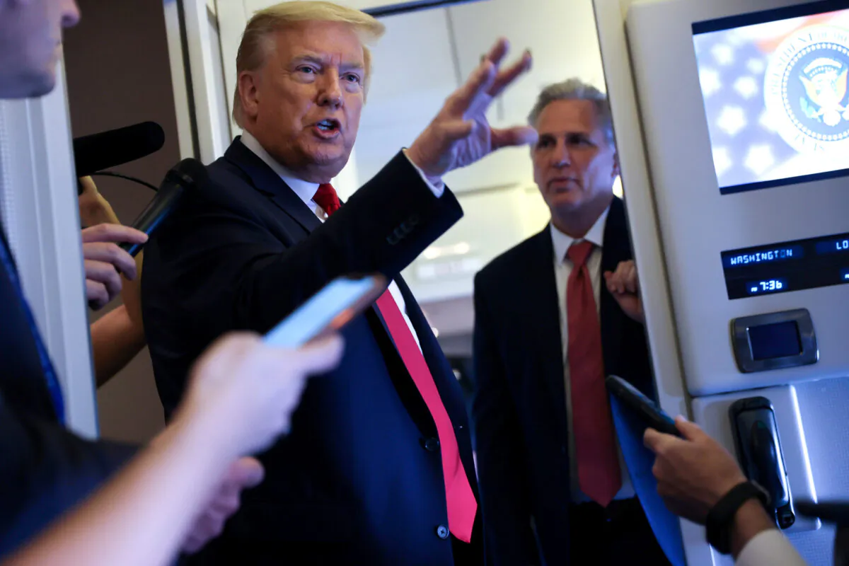 President Donald Trump, with House Minority Leader Kevin McCarthy (R-Calif.), speaks to reporters aboard Air Force One while returning to Washington from Cape Canaveral, Fla., on May 30, 2020. (Jonathan Ernst/Reuters)