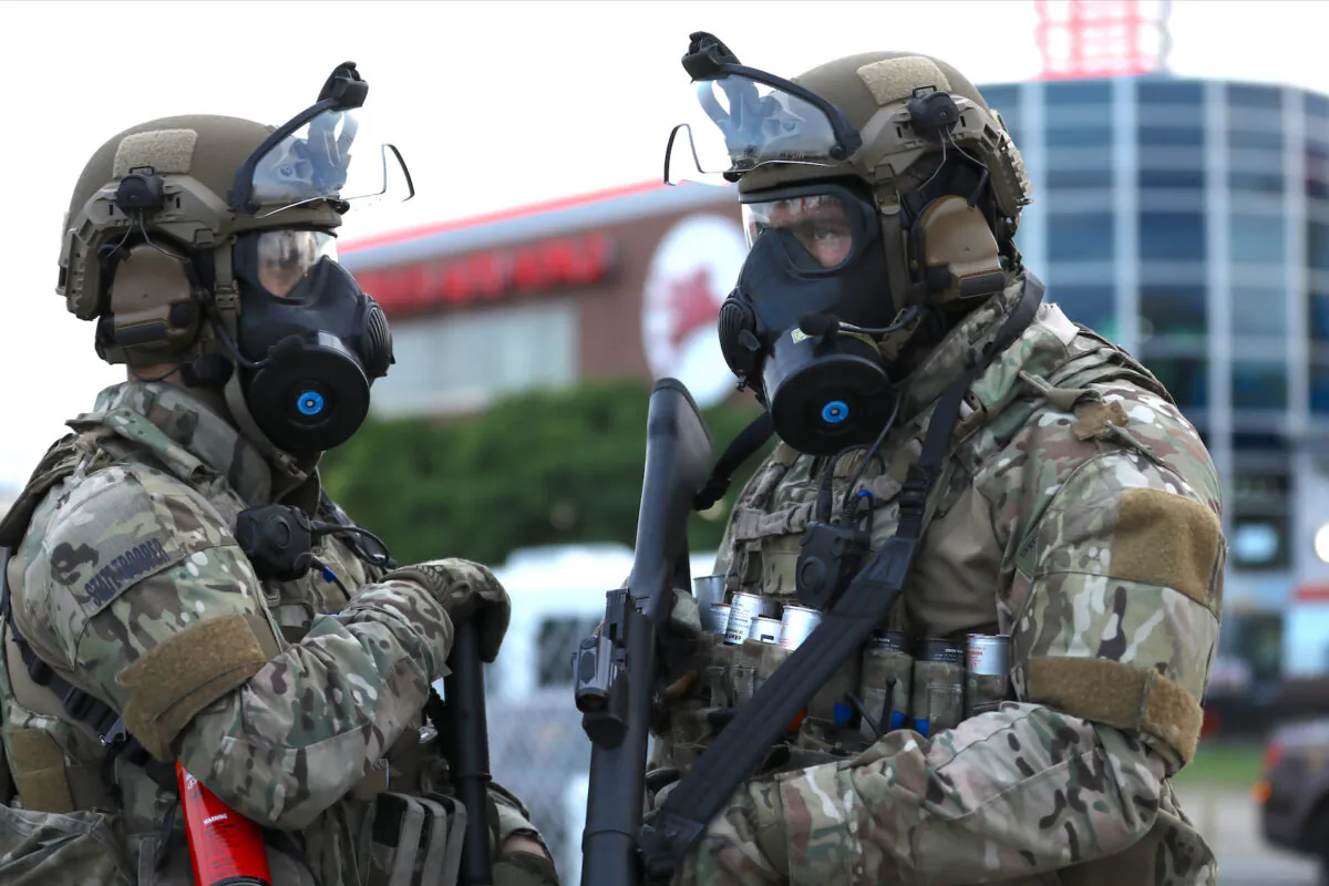 Two State Troopers are ready to contain protesters who stay out after the Governor’s 8 p.m. curfew on the sixth night of protests and violence following the death of George Floyd, in Minneapolis, Minn., on May 31, 2020. (Charlotte Cuthbertson/The Epoch Times)